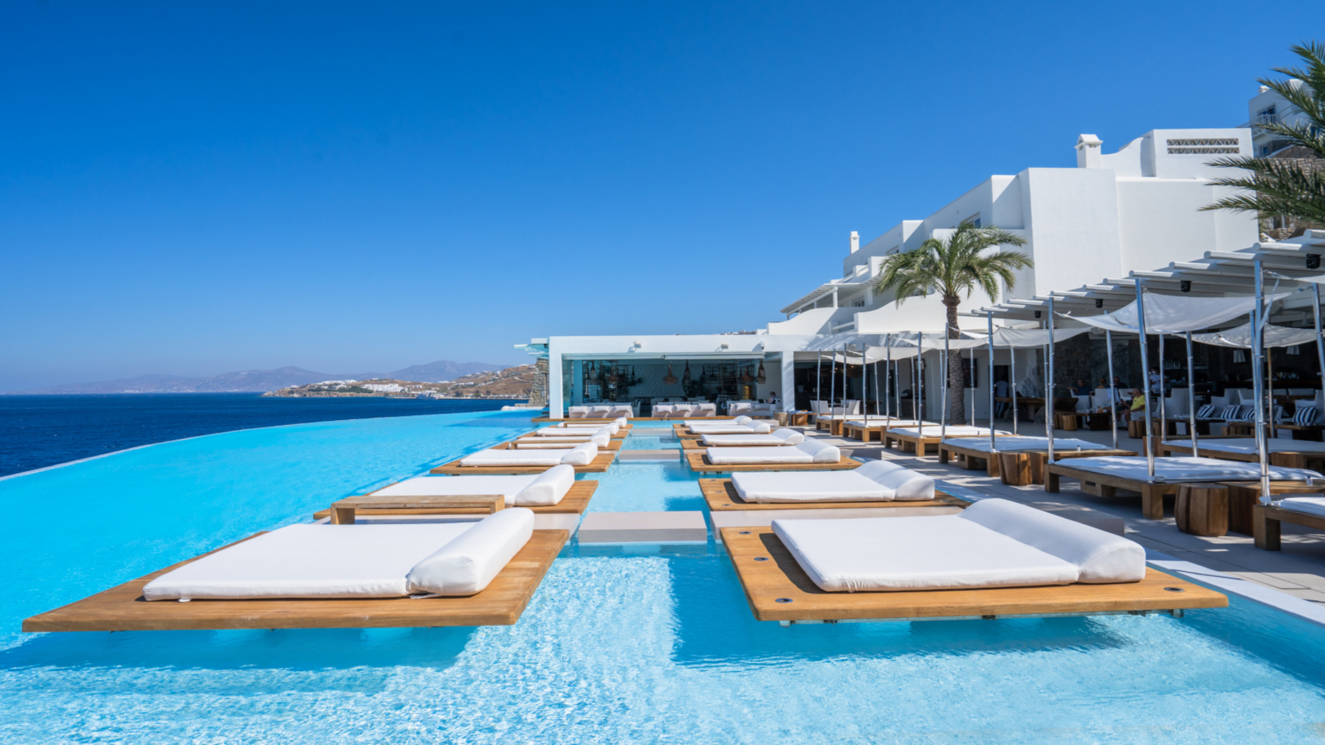 Cavo Tagoo Mykonos infinity pool with in-water fish tank and Aegean view