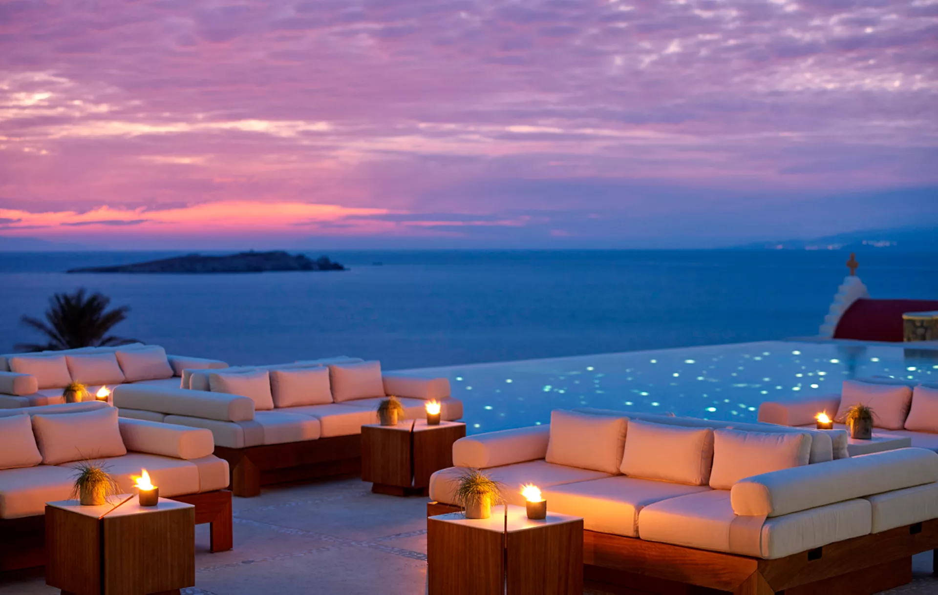 Bill & Coo Mykonos infinity pool at sunset above Megali Ammos beach