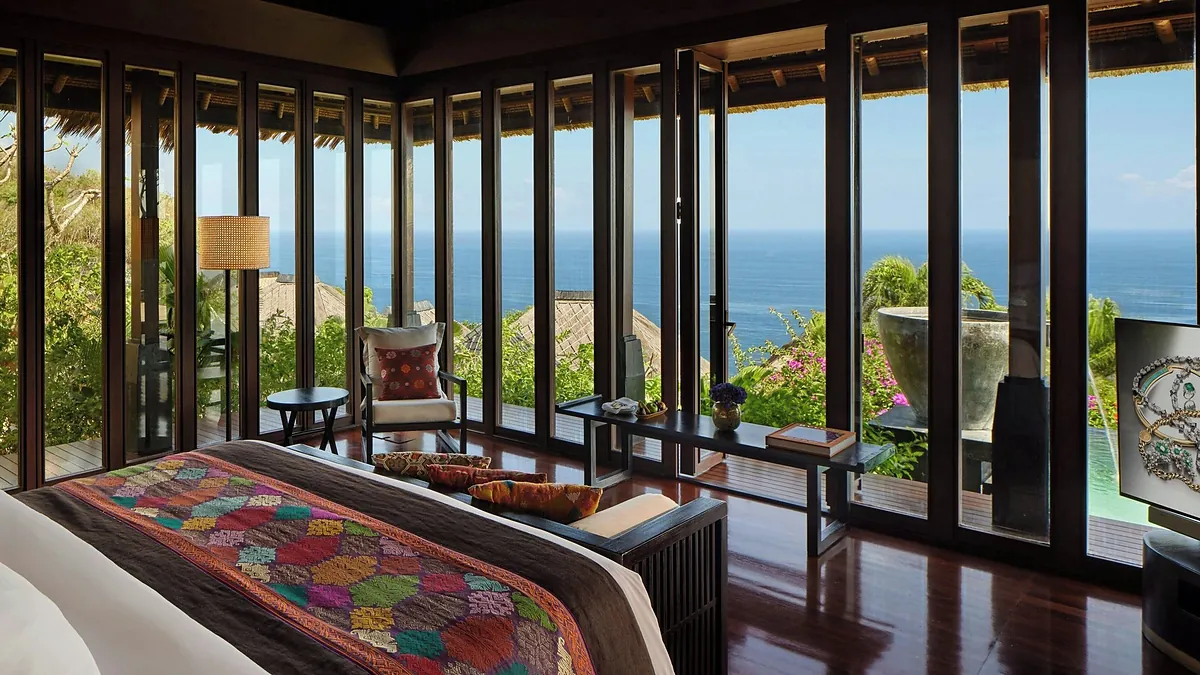 Premier villa bedroom at Bvlgari Resort Bali with floor to ceiling windows facing the ocean