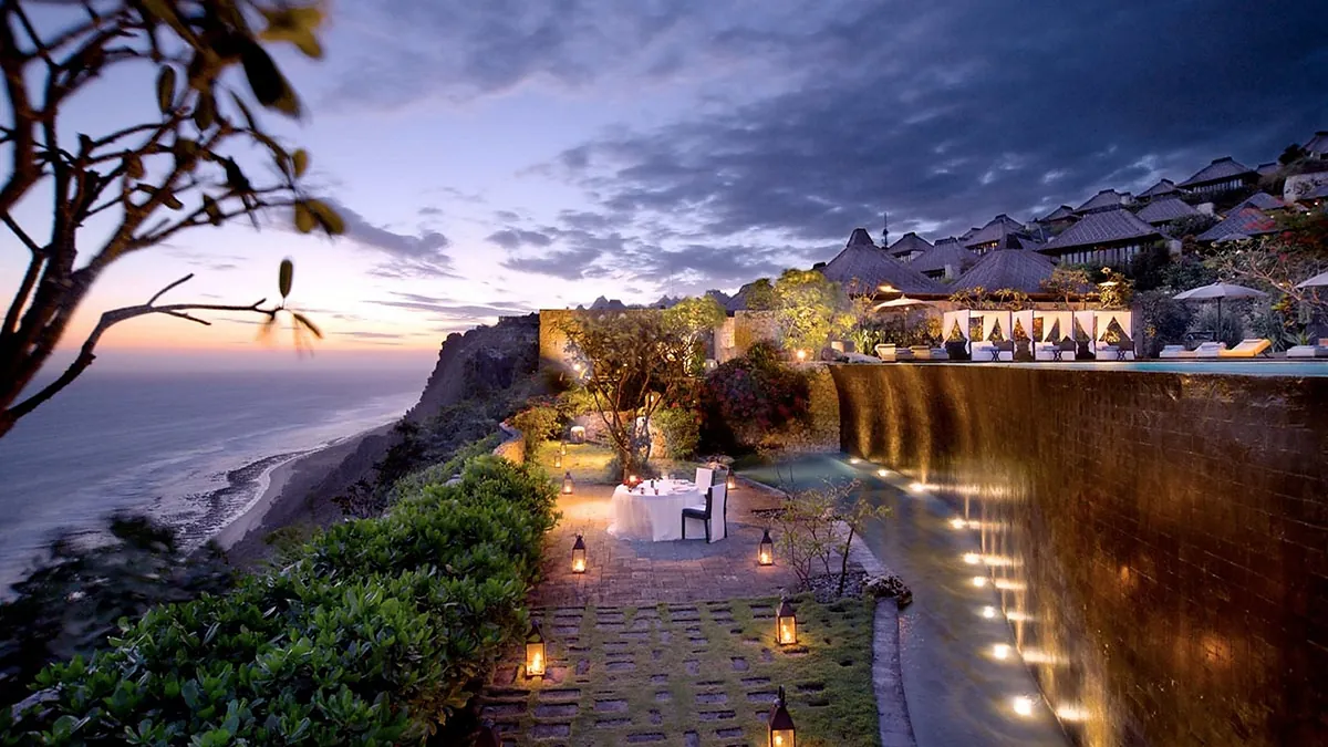 Private cliff edge dinner at dusk with lanterns at Bvlgari Resort Bali