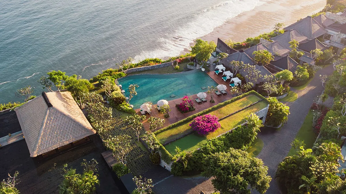 Aerial view of the clifftop pool and bougainvillea at Bvlgari Resort Bali above the Indian Ocean