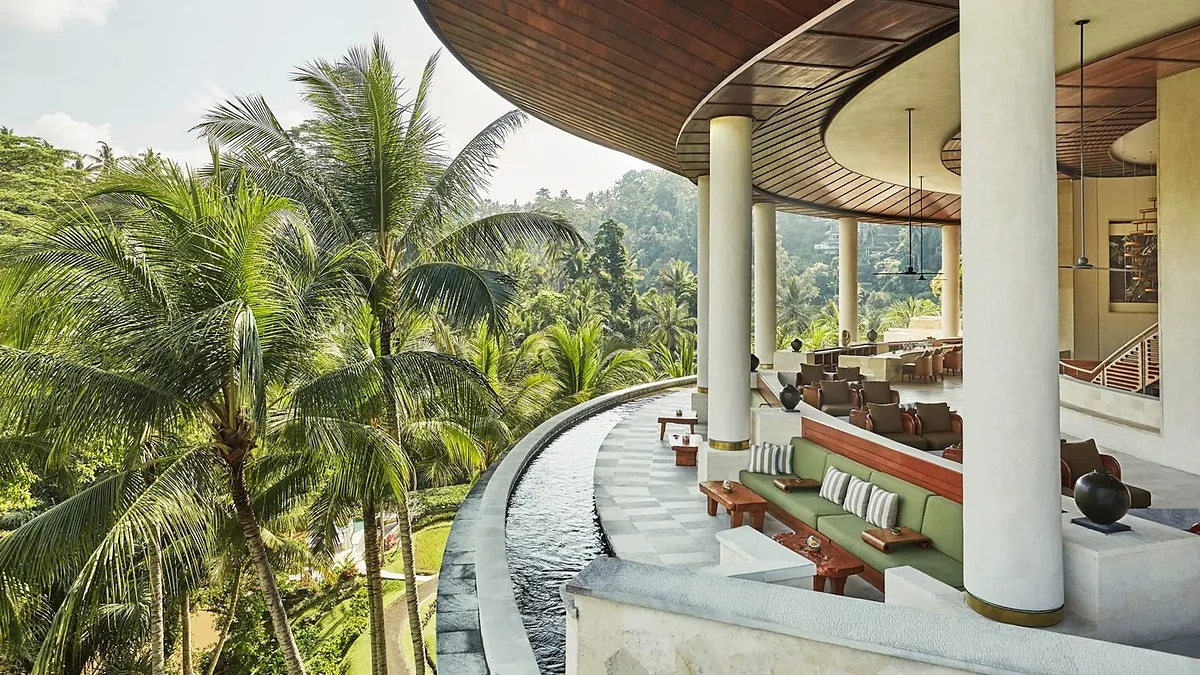 Curved open sided lobby at Four Seasons Sayan looking out over palms to the Ayung River valley