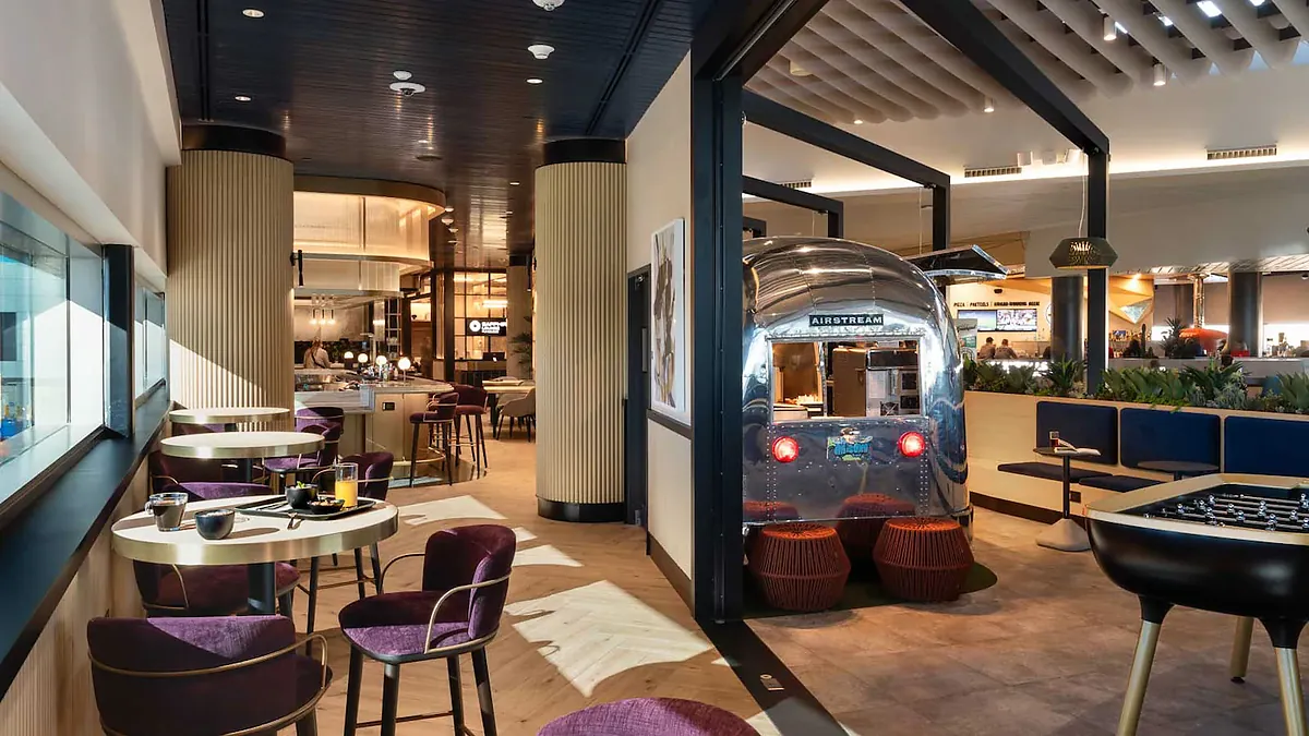 Inside a premium card lounge with dining tables and natural light