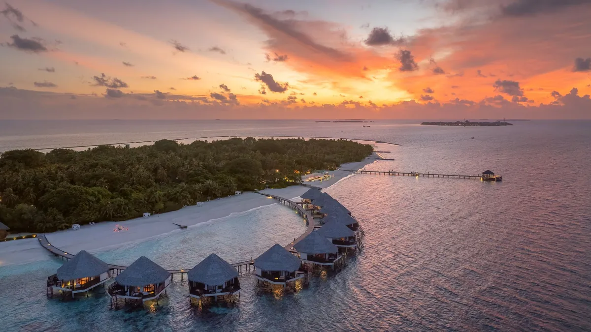 Overwater villas at sunset in Raa Atoll, Maldives