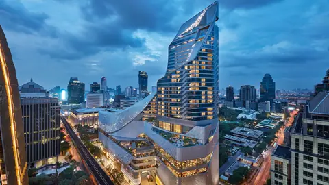 The Park Hyatt Bangkok tower lit at dusk above the Central Embassy building