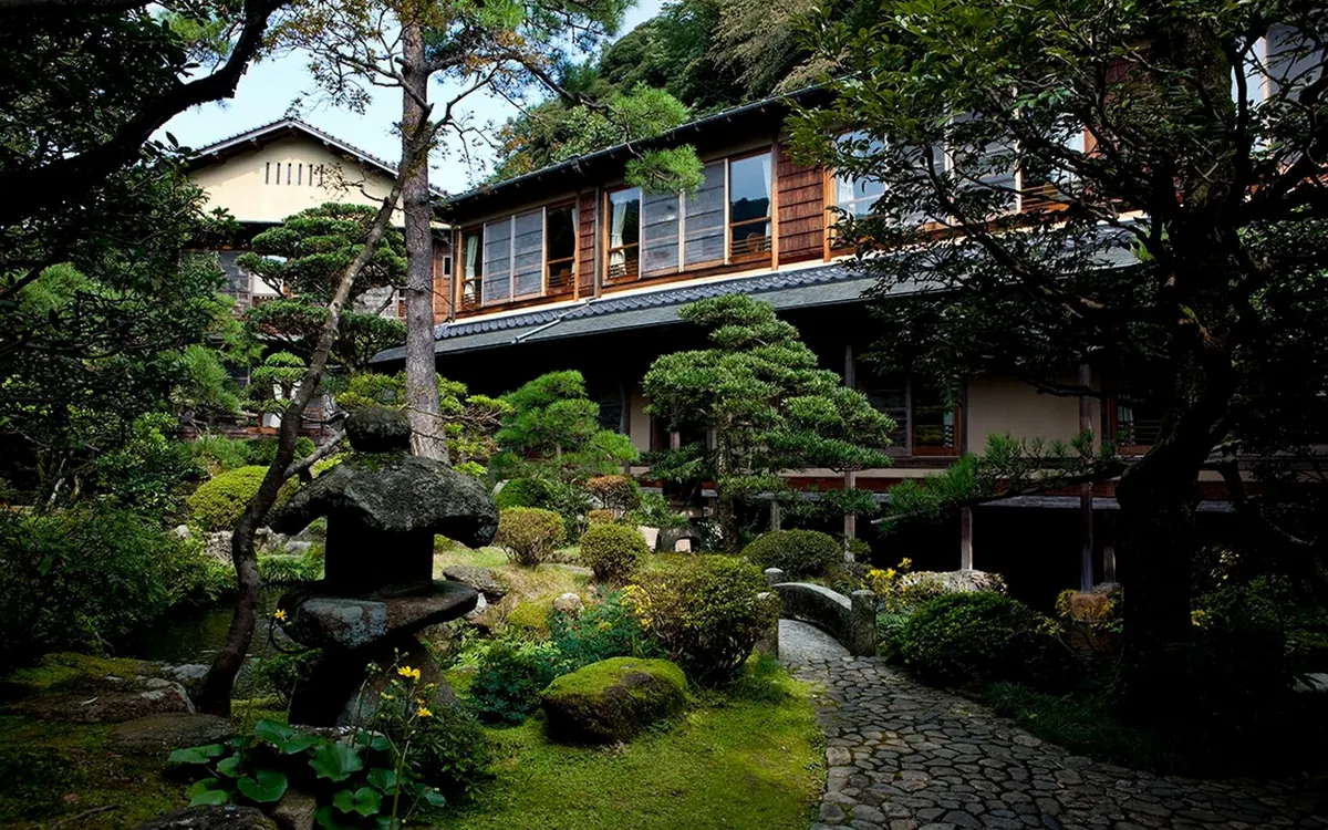 Nishimuraya Honkan, garden exterior with pines and traditional building, Kinosaki Onsen
