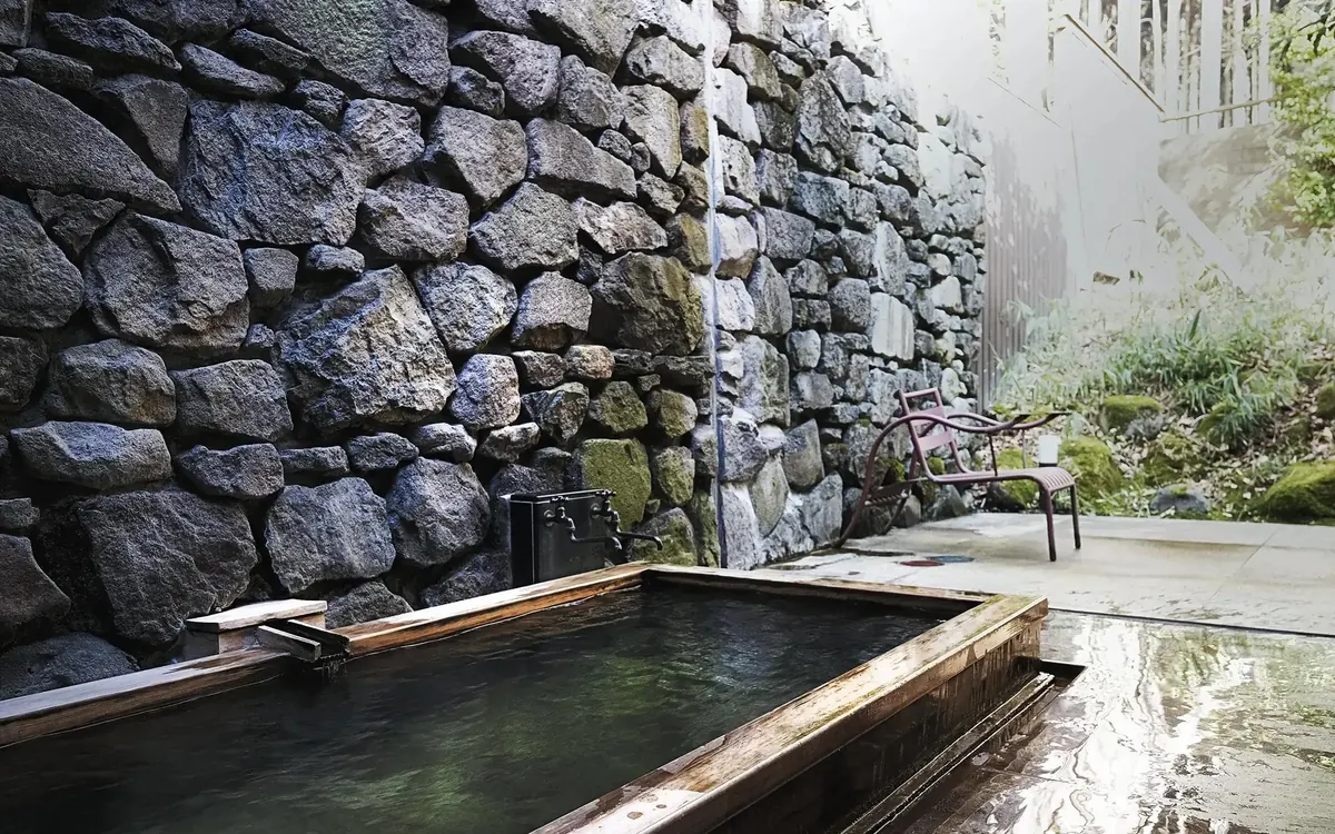 Sanso Murata, private open air onsen bath against a stone wall (Higashi room), Yufuin