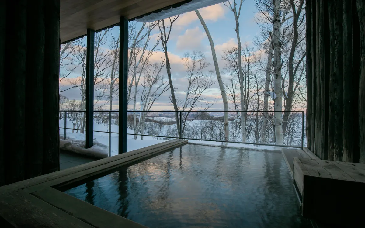 Zaborin, indoor onsen bath with snowy forest view, Niseko