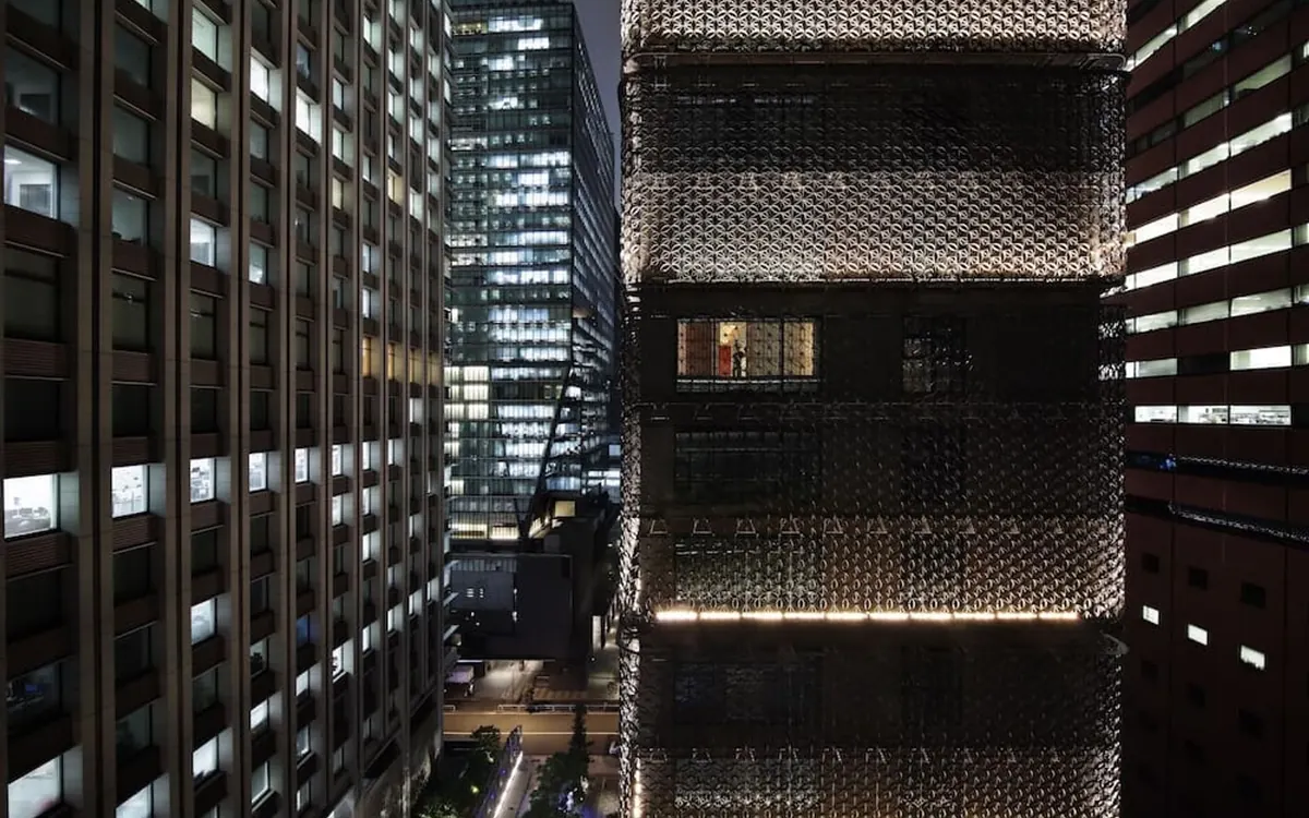 HOSHINOYA Tokyo, the tower at night wrapped in its komon pattern lattice facade, Otemachi