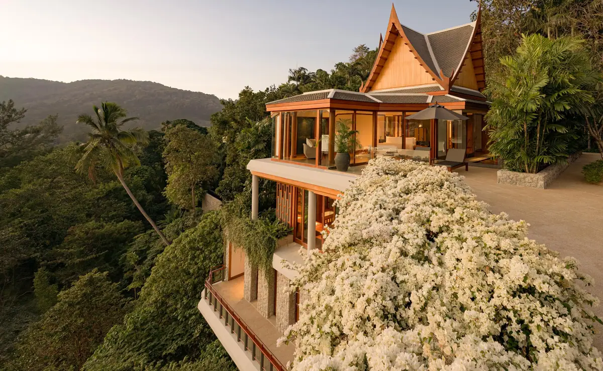 A timber Thai pavilion on a wooded headland above the sea