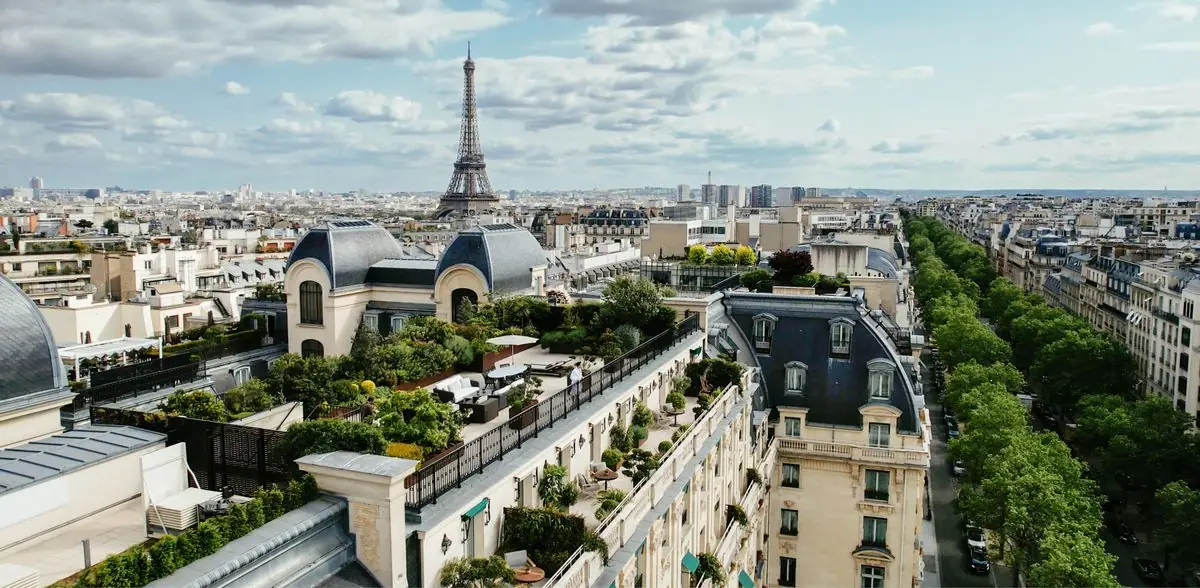 Zinc rooftops and a tall iron tower on the skyline seen from a hotel roof