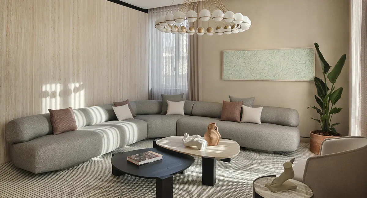 A sitting room in pale lime plaster with a low sofa and a long window