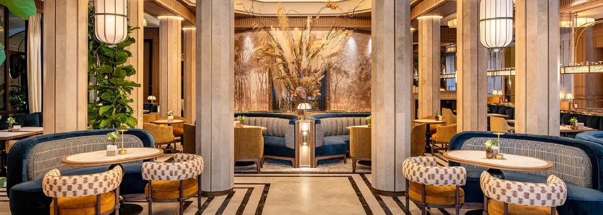 A columned dining room at Bless Hotel Madrid with dried flowers and blue banquettes
