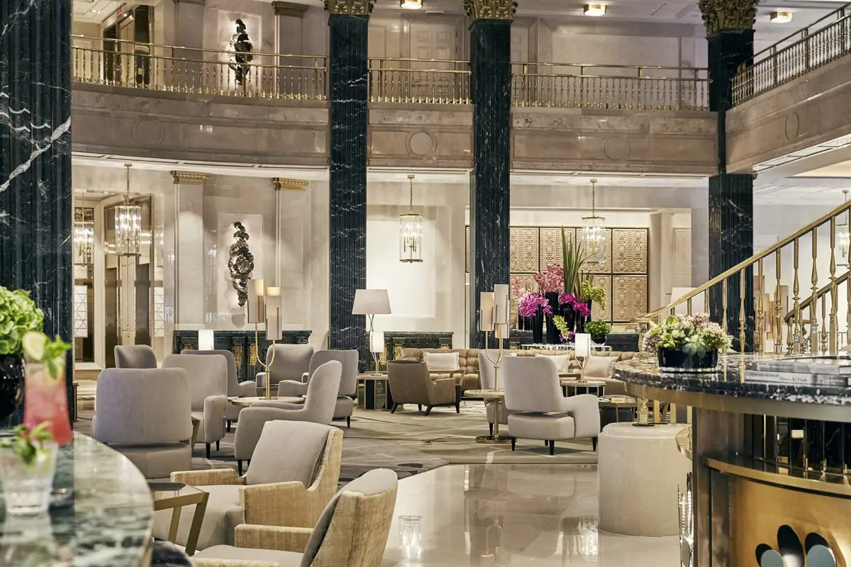 The two storey lobby of Four Seasons Hotel Madrid with marble floors and columns