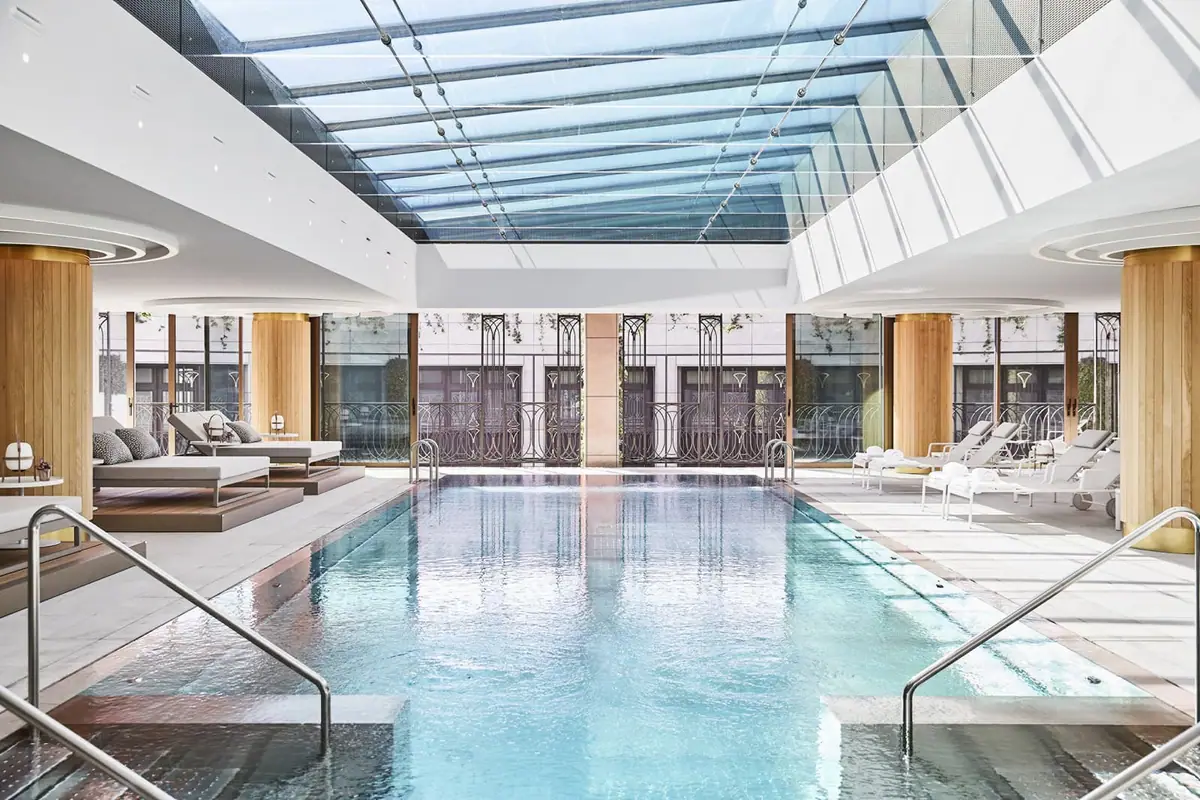 The indoor swimming pool at Four Seasons Hotel Madrid under a full length skylight