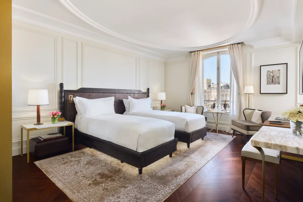A guest room at Mandarin Oriental Ritz Madrid with a dark wooden bed and panelled walls