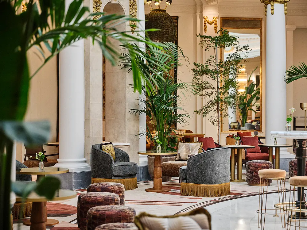 The rotunda restaurant at The Palace Madrid with palms and marble columns under the dome