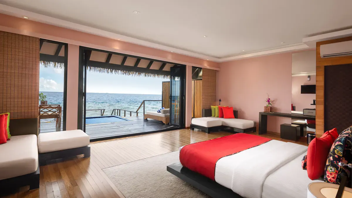 Overwater villa bedroom with lagoon view at Adaaran Prestige Vadoo