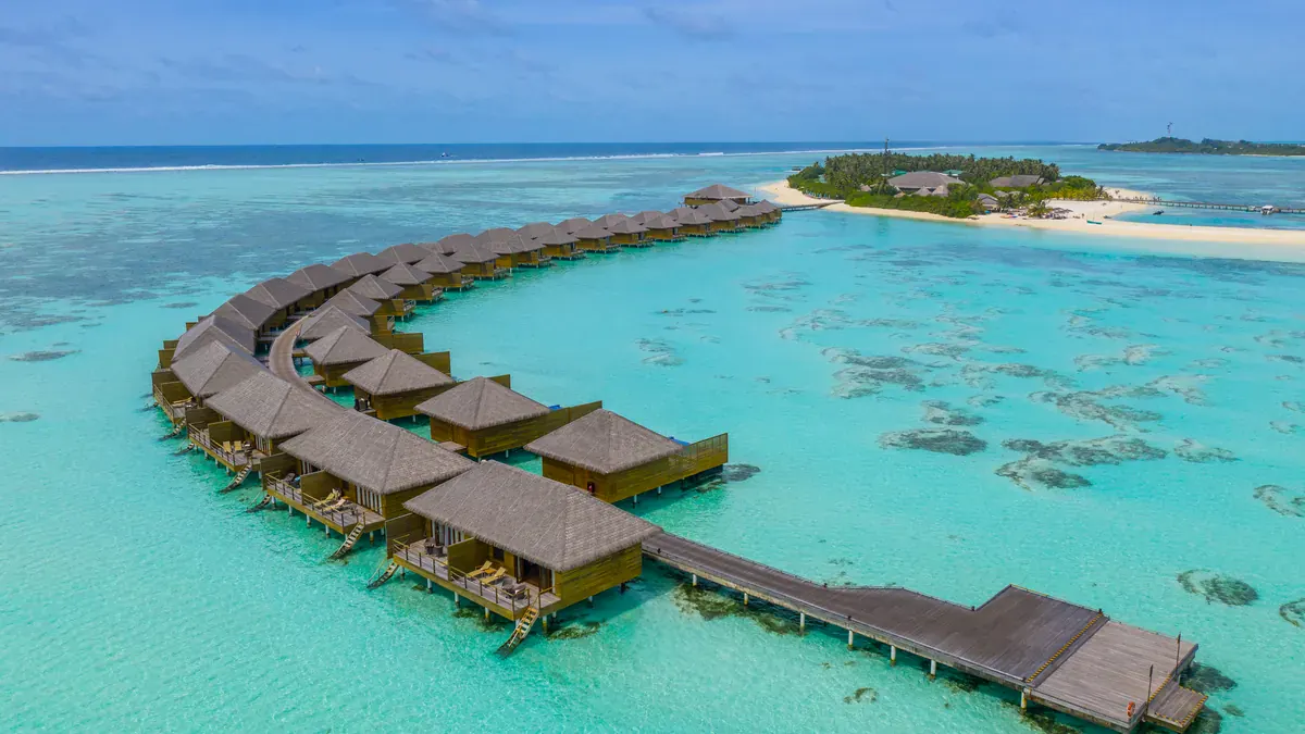 Aerial view of the overwater suites at Cocoon Maldives in Lhaviyani Atoll