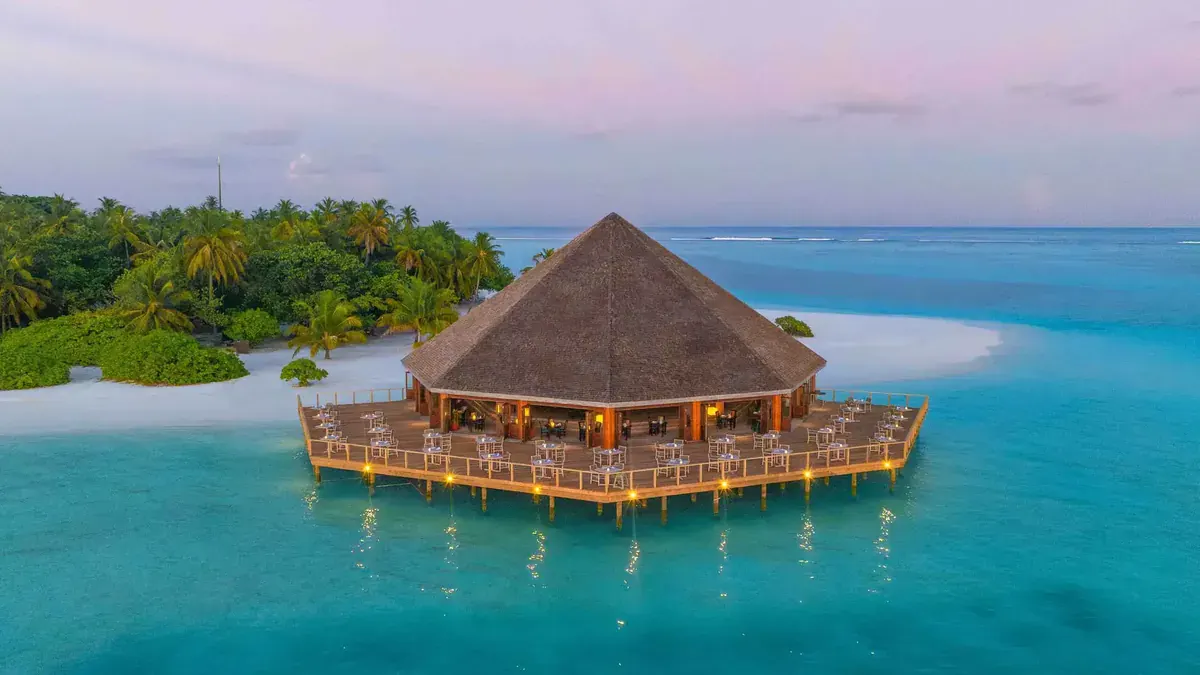 Overwater restaurant at Meeru Maldives at dusk
