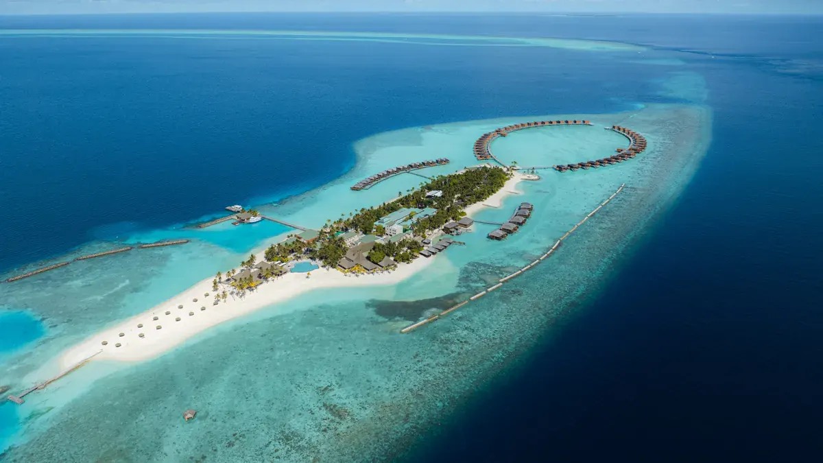 Aerial view of Veligandu Island Resort and its water villas in Ari Atoll