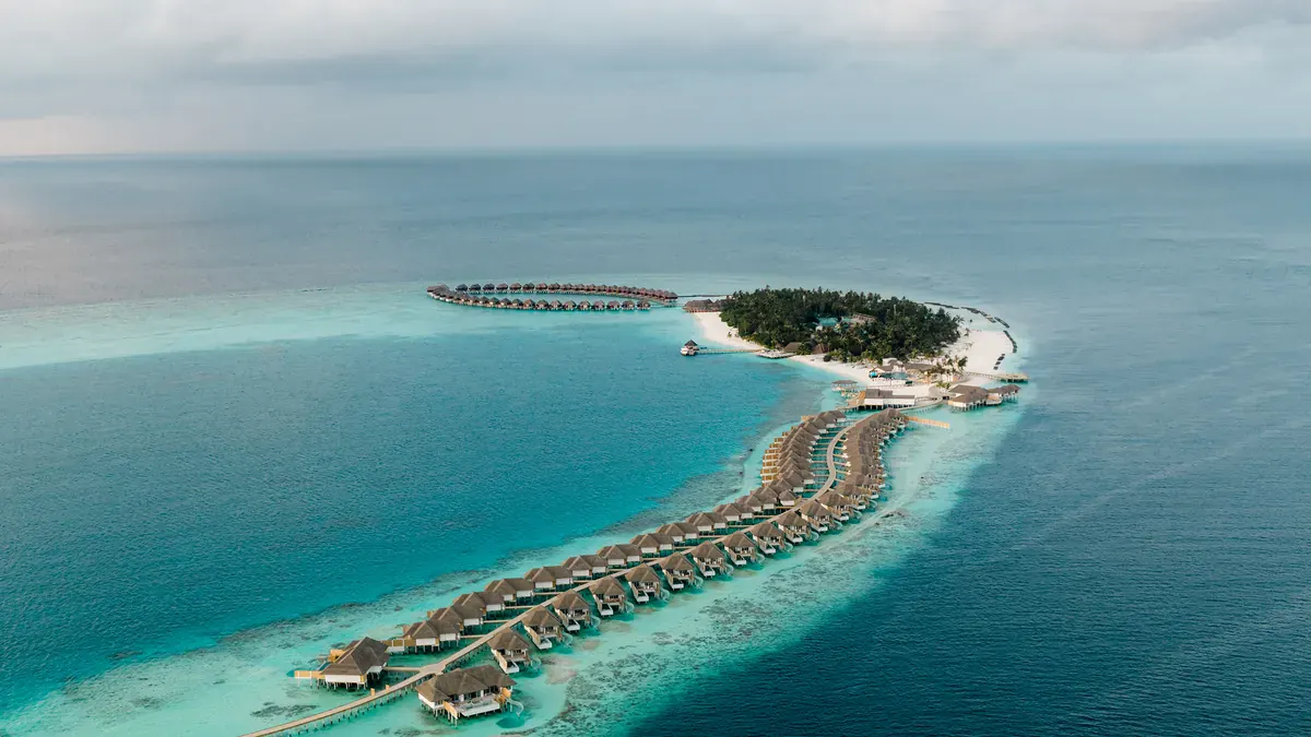 Aerial view of Sun Siyam Vilu Reef island and its overwater villas