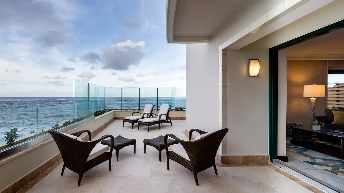 Suite terrace with dark wicker chairs and loungers looking straight out over the Atlantic