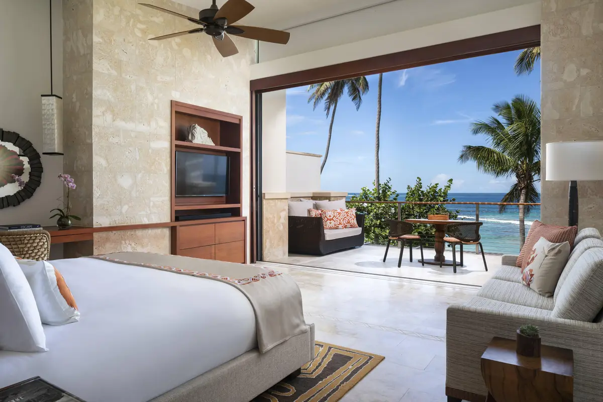 Guest room with sliding doors opening onto a private terrace and plunge pool