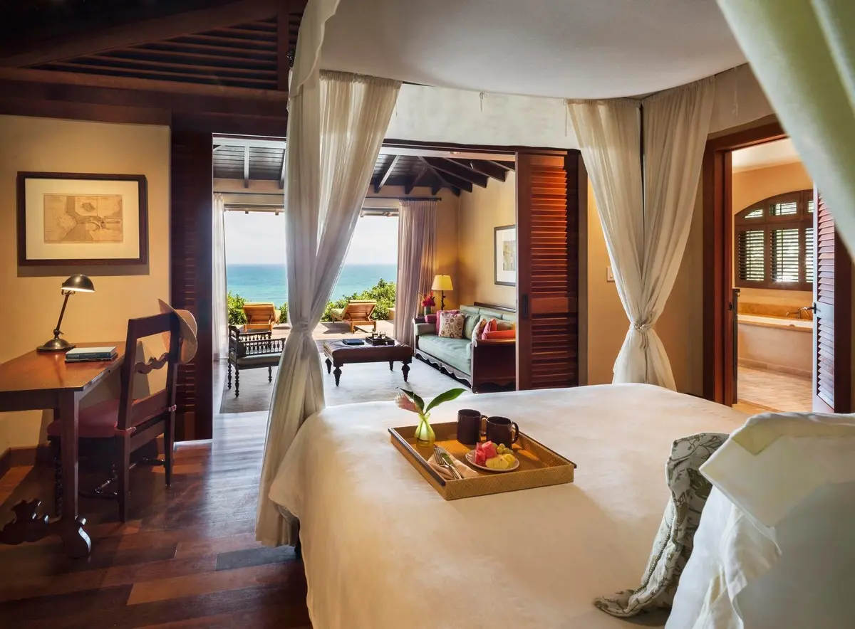 Casita interior in dark mahogany with built in bookcases framing a canopied bed