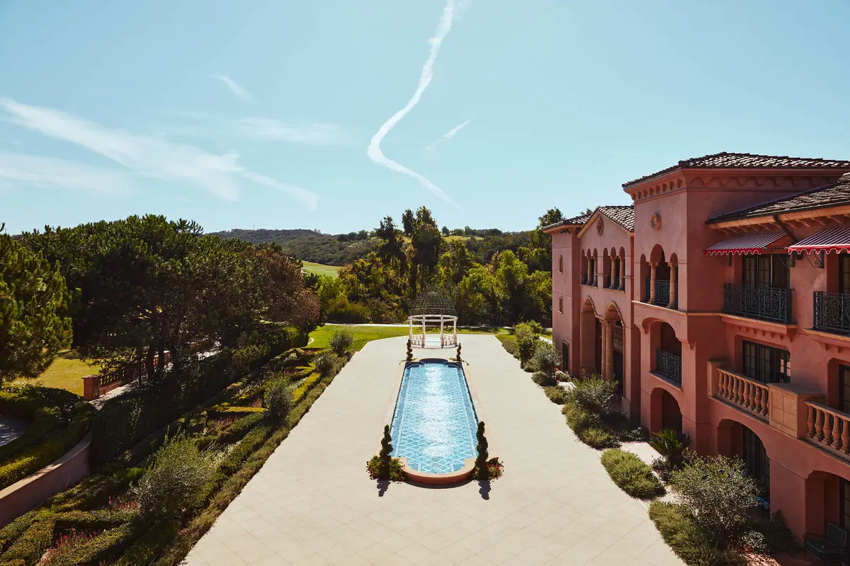 A long reflecting pool leading up to the main building at Fairmont Grand Del Mar