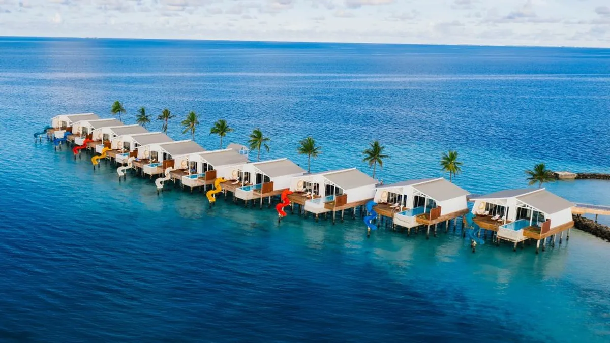 Oaga Art Resort water villa with a private slide and Maldivian art design