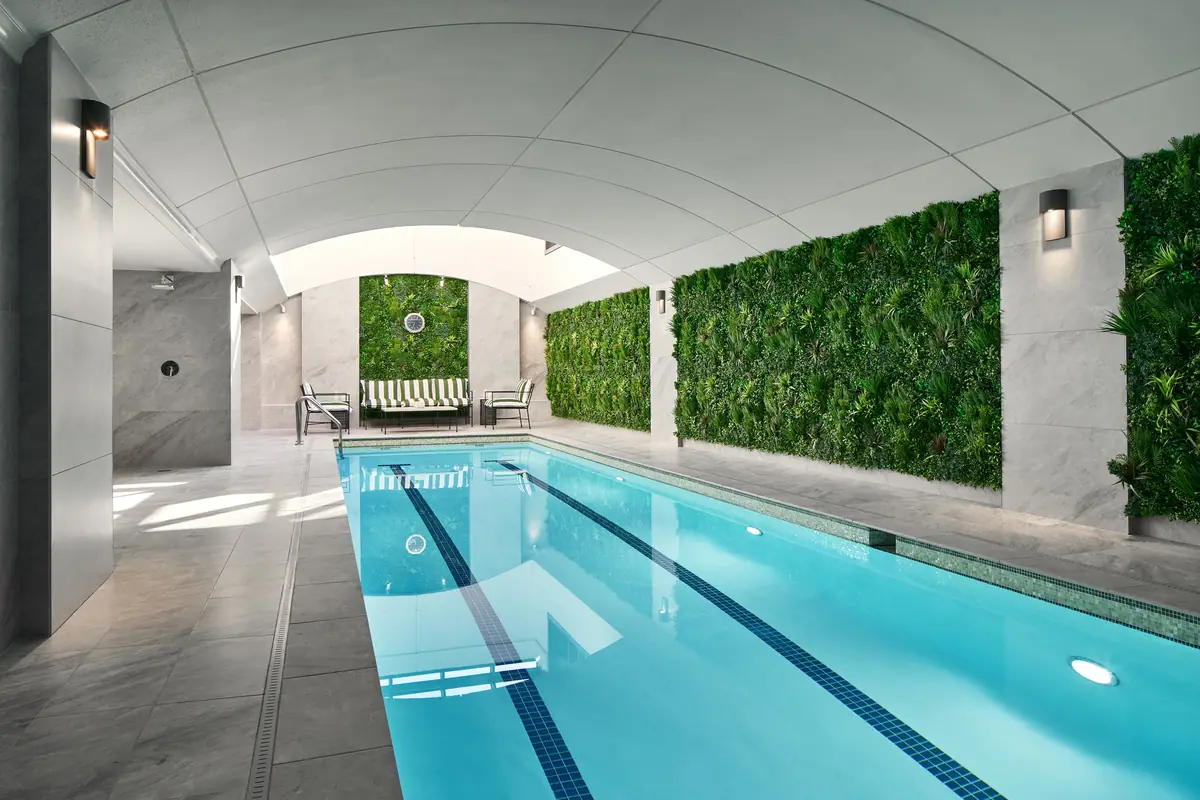 The indoor saltwater lap pool at the Four Seasons Washington DC under a vaulted ceiling