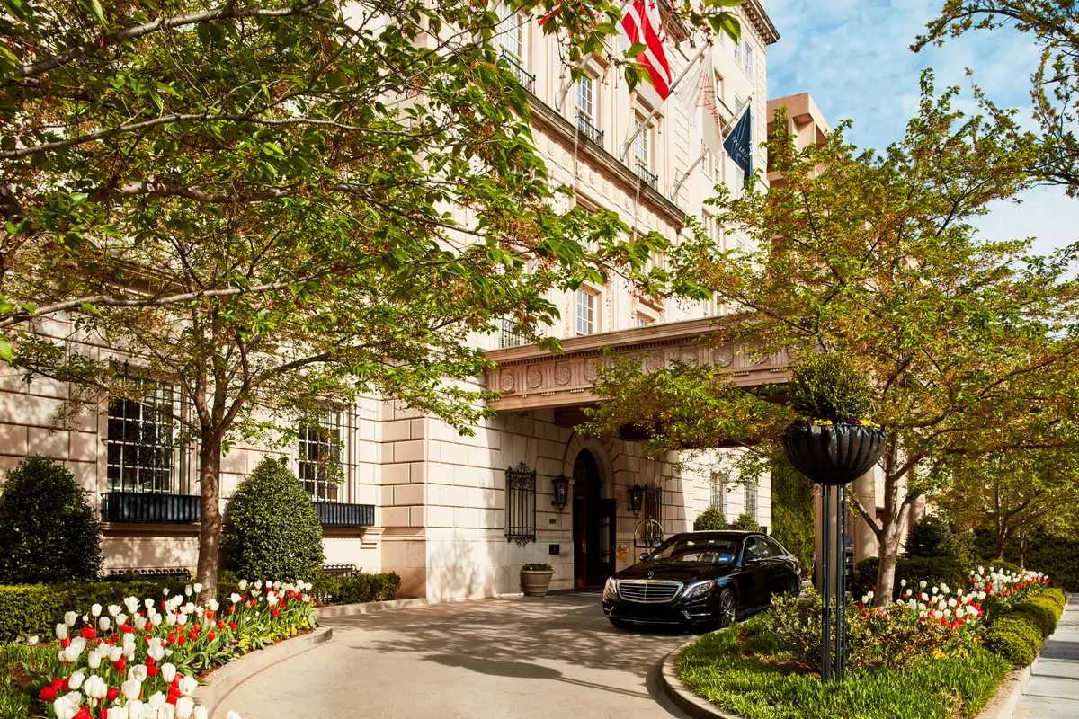 The entrance canopy of the Hay Adams with clipped planting and a car at the door