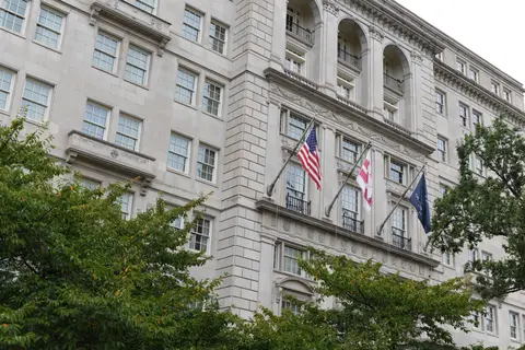 The upper storeys of the Hay Adams with flags flying from the facade
