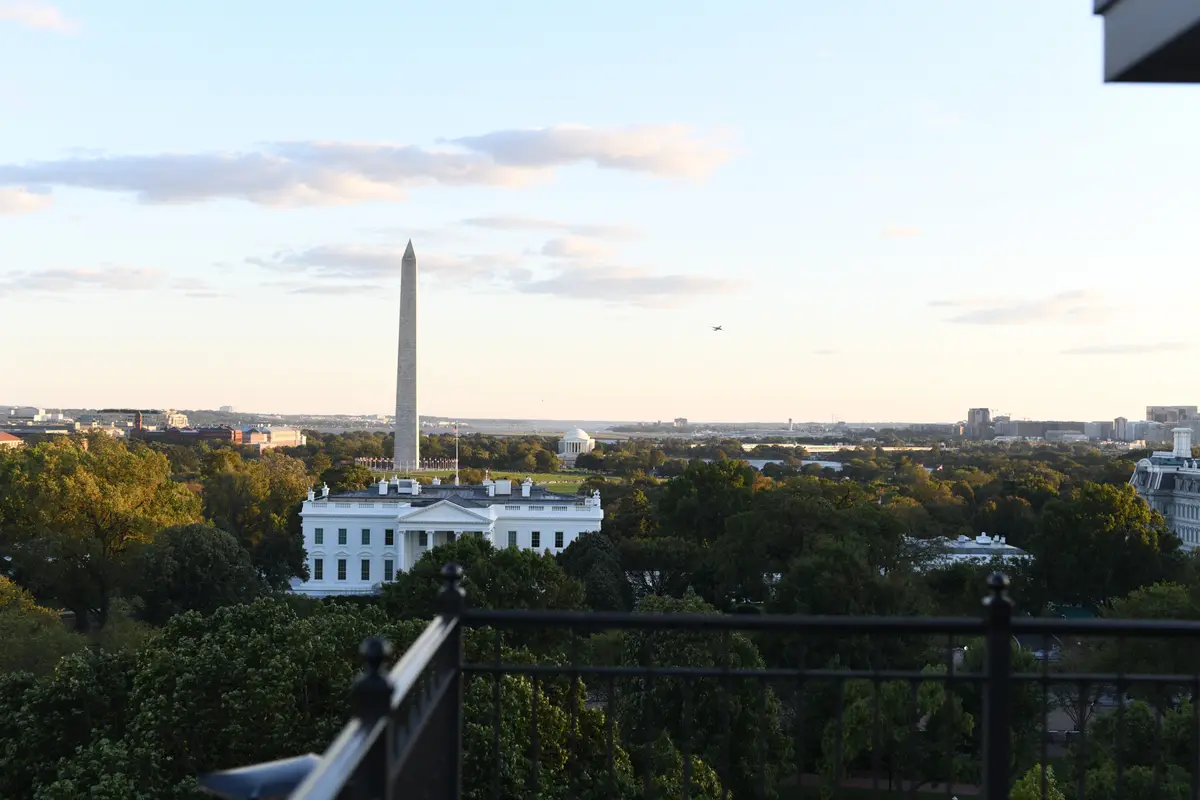 The White House and the Washington Monument seen over treetops from the roof terrace of the Hay Adams