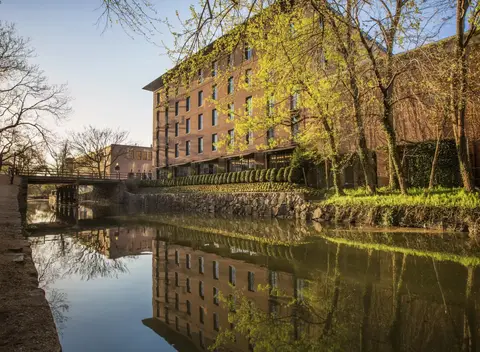 The Rosewood Washington DC seen across the C and O Canal in spring