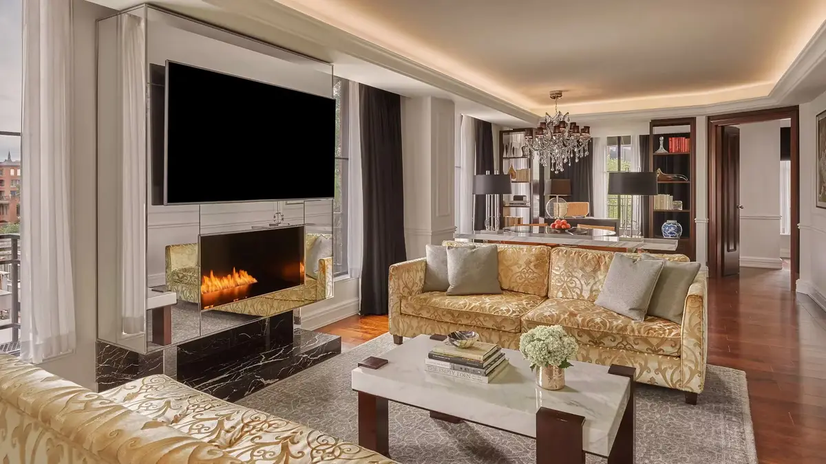 The living room of the Presidential Suite at the Rosewood Washington DC with a fireplace