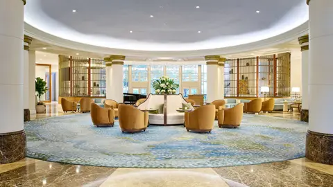 The circular lobby of the hotel at 1330 Maryland Avenue with a patterned carpet and curved seating