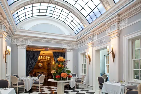 The Greenhouse restaurant at The Jefferson under its arched glass skylight