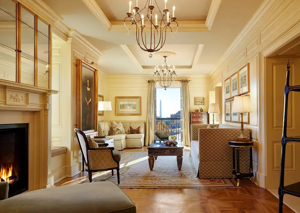 The parlour of the Presidential Suite at The Jefferson with a lit fireplace
