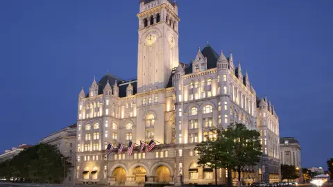 The Old Post Office building lit at night on Pennsylvania Avenue