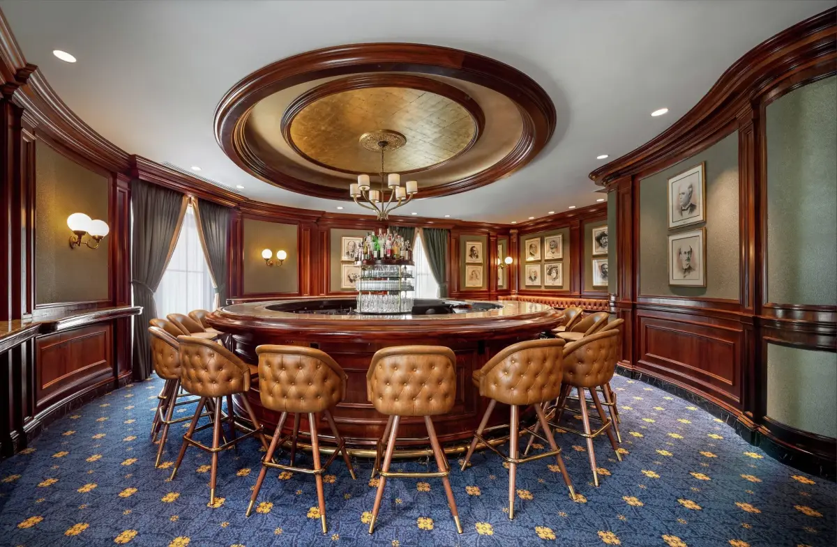 The circular bar at the Round Robin with leather stools under a domed ceiling