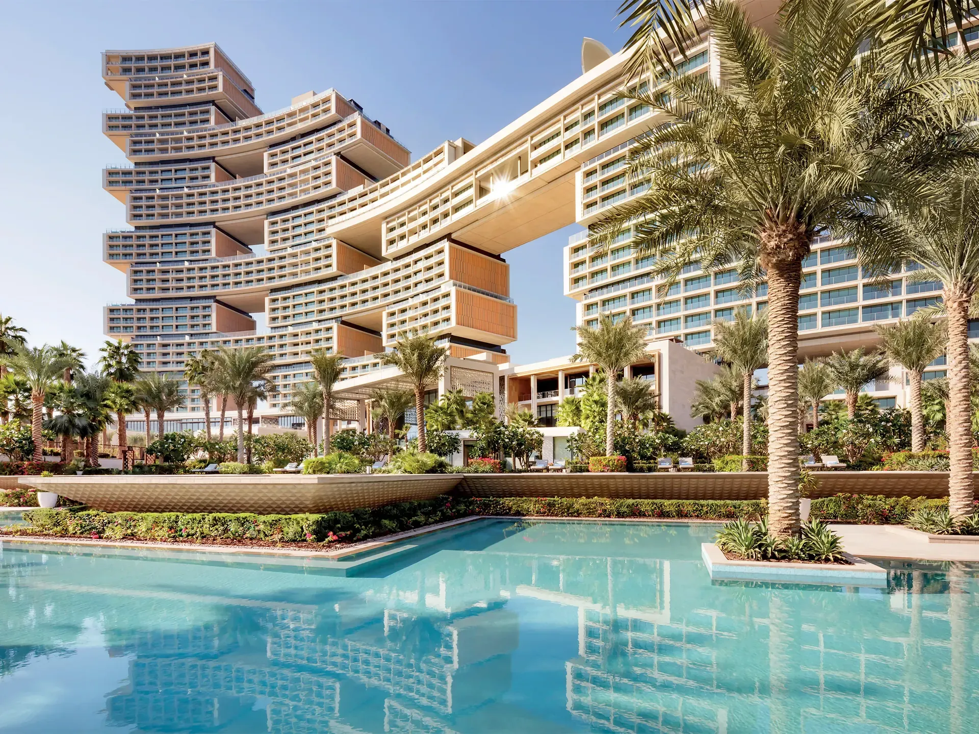 Modern luxury hotel towers along the Dubai coastline at dusk