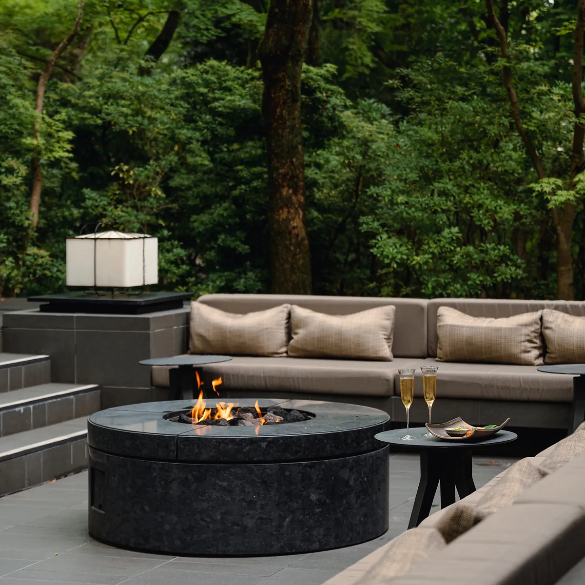Aman Kyoto, the outdoor stone fire pit set with two glasses, Kyoto