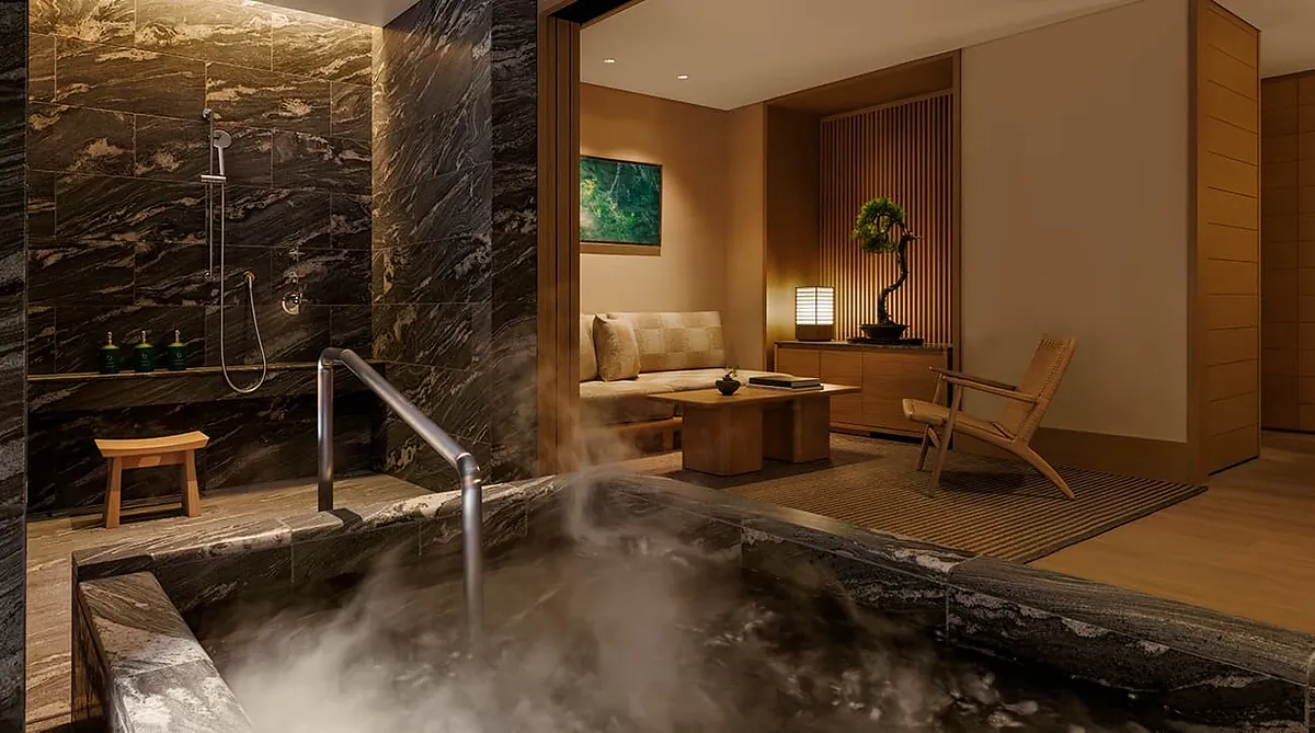 Capella Kyoto, a steaming stone bath in a dark marble bathroom, Kyoto