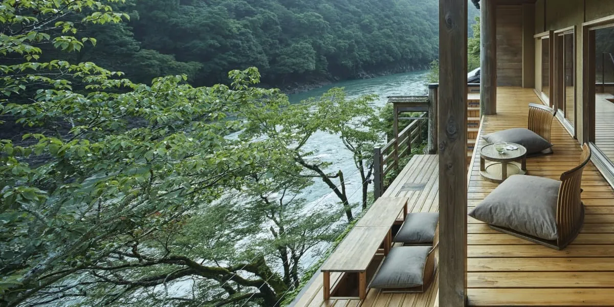 HOSHINOYA Kyoto, terrace seating above the river with the gorge beyond, Kyoto
