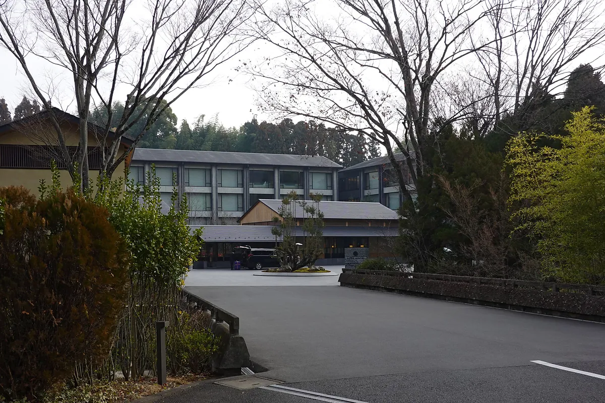 ROKU KYOTO LXR, the low hotel building behind winter trees, Kyoto