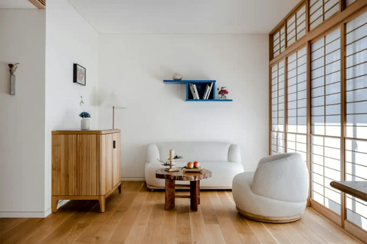 The Shinmonzen, a white sitting room with timber cabinet and round chair, Kyoto