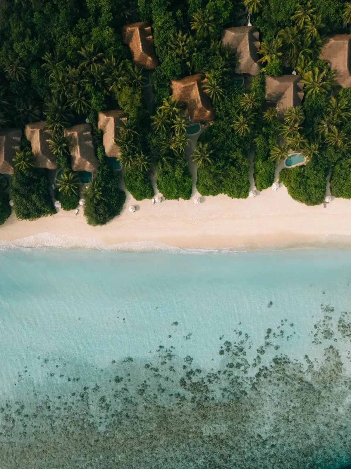 Soneva Jani vs Soneva Fushi: Overwater Drama or Barefoot Jungle?, Aerial view of Kunfunadhoo, the jungle island home of Soneva Fushi in Baa Atoll