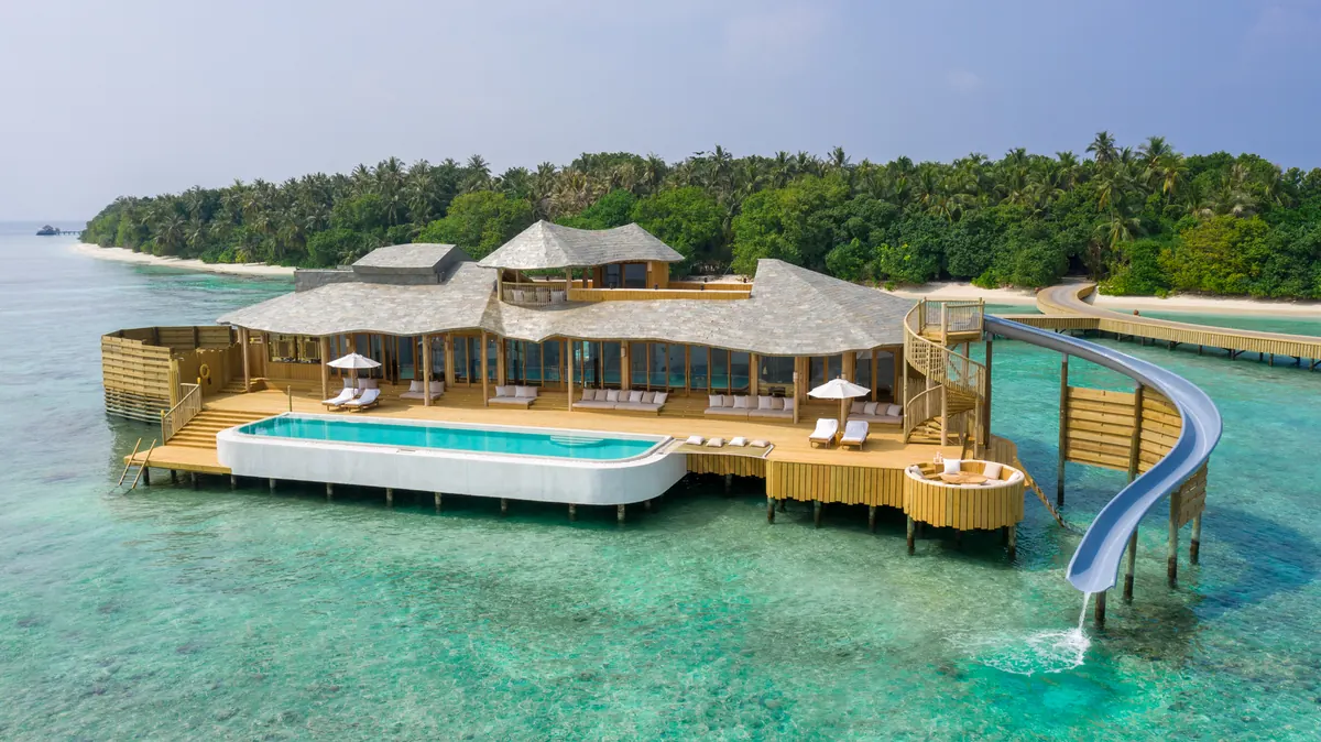 Soneva Jani vs Soneva Fushi: Overwater Drama or Barefoot Jungle?, One of Soneva Fushi's overwater villas with its slide into the lagoon
